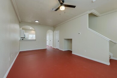 Unfurnished living room with arched walkways, a c