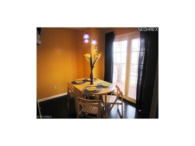 Eat in kitchen area has hard wood floors,window tr