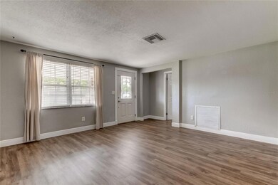 Living Room/Door To Right Of Front Door Leads To Third Bedroom.