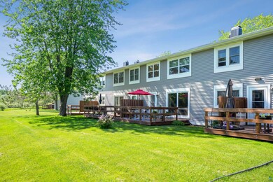 Rear view of house featuring a wooden deck and a y