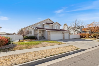 Traditional-style house featuring a large concrete driveway, stucco siding, and a 3-car garage