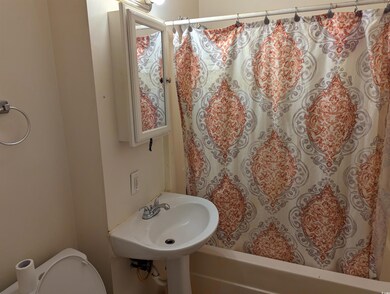 Full bath featuring toilet and shower / bath combo