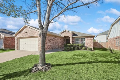Single story home with a front yard and a garage