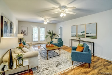 Living room with ceiling fan, french doors, and hardwood / wood-style floors
