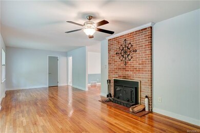 Huge family room with beautiful hardwood floors and a brick wood burning fireplace
