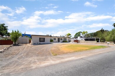View of front facade with curved driveway and a ca