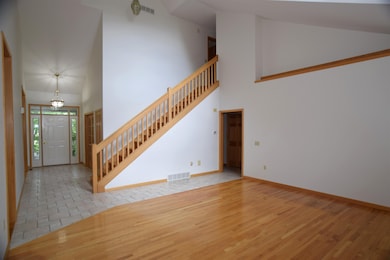 In the living room you will see the front entrance and the staircase leading to the second floor.  The side doorway leads to the master suite and additional spaces.