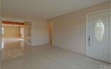 Living room view of entry to home.