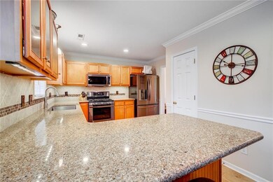 Take a closer look at the shining granite counter that compliments the new kitchen cabinets and new backsplash so well!