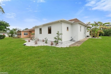 Back of house with a lawn