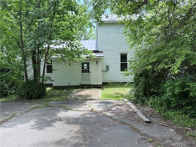 Back of property with metal roof