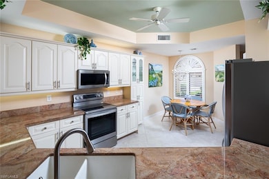 Kitchen featuring baseboards, stainless steel appl