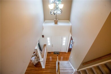 FRONT ENTRY FOYER W/ HARDWOOD FLOORING THROUGH THE