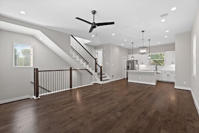 Experience the living area with seamless access to the third floor, accompanied by the convenience of a half bathroom