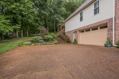 Large aggregate drive and side entry two car garage.