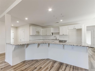 Kitchen with recessed lighting, wood finish floors