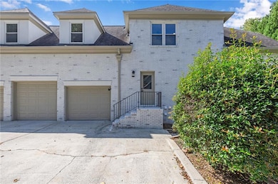 Traditional home with driveway, a garage, and brick siding