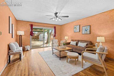 Living room with light hardwood / wood-style floor