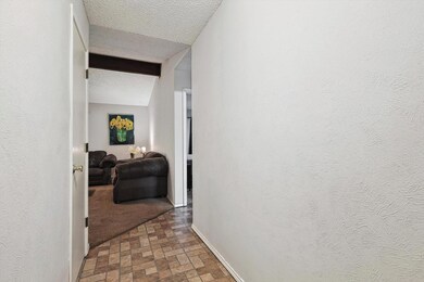 Corridor featuring carpet floors and a textured ceiling