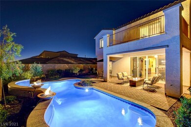 Custom pool with waterfall and fire pits.