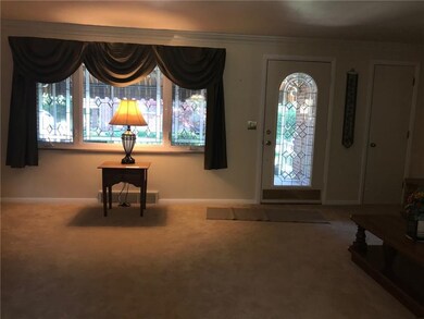 Living room has newer beige carpet.  Leaded glass 
