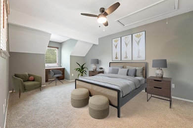 Bedroom with attic access, light carpet, baseboar