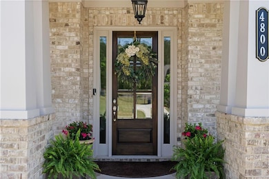 Doorway to property with brick siding