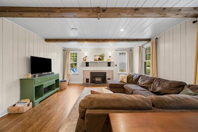 Anchored by a charming fireplace, it provides a wa