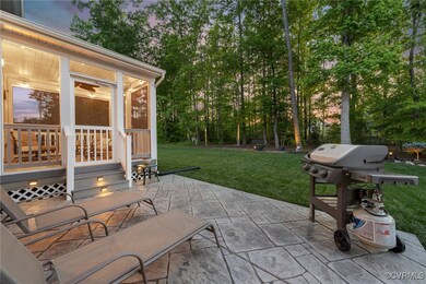 Patio terrace at dusk featuring a yard, a sunroom,