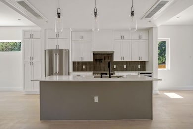 Kitchen featuring a sink, freestanding refrigerat