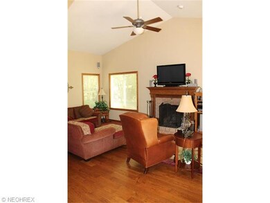 The great room has a cathedral ceiling and a wood 