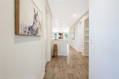 Corridor featuring light wood-type flooring and recessed lighting