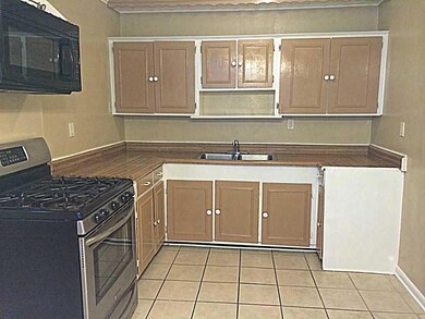 Photo. Kitchen has 5 burner gas range/oven, microw