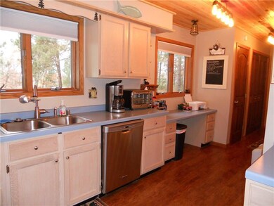 Another view of the kitchen showing the new stove-top, microwave, and refrigerator.