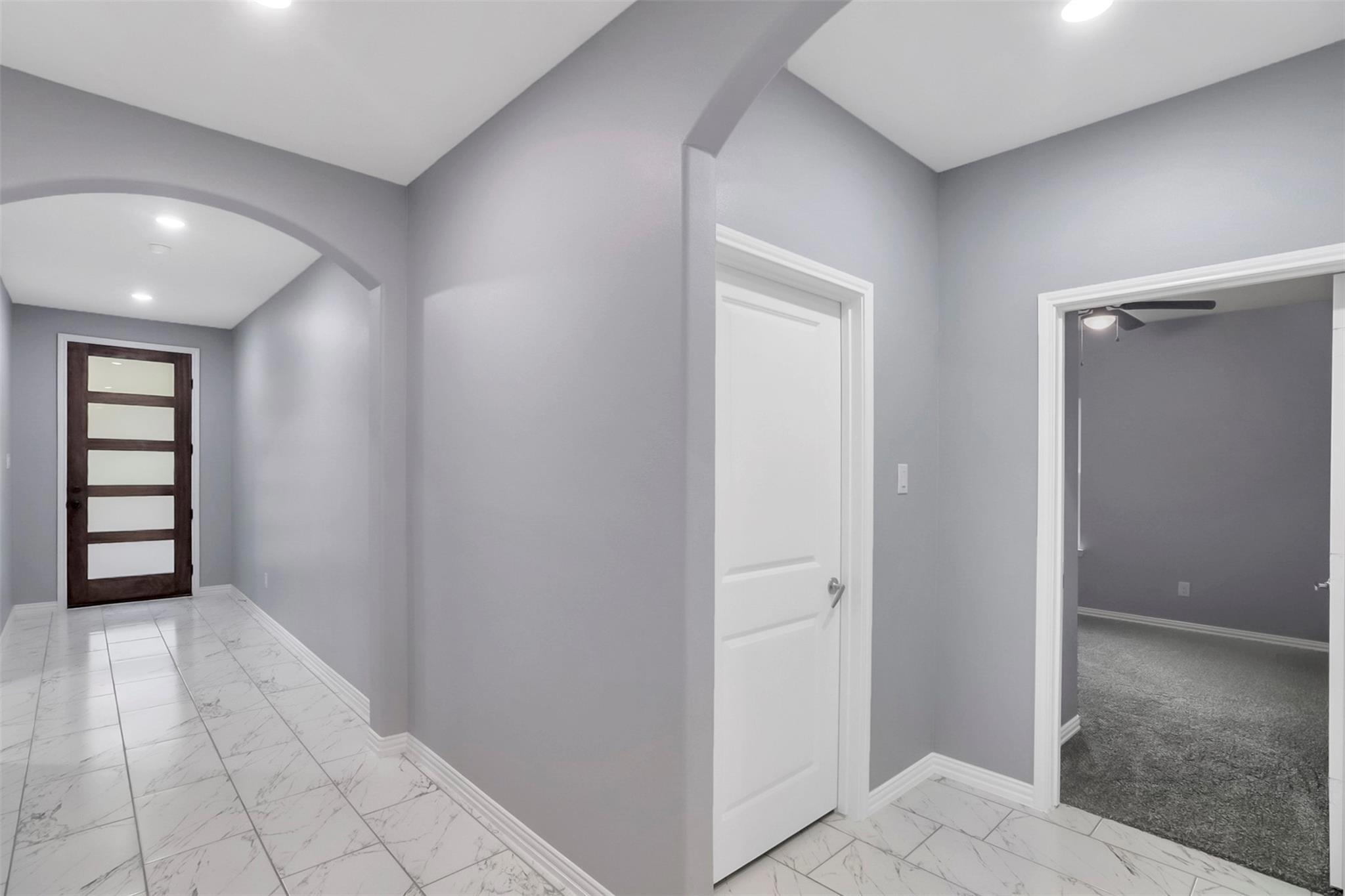 Hall featuring light colored carpet