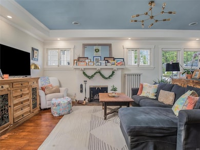 Another view from the dining room. check out the windows that flank the fireplace and the modern light fixture.