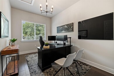 Office space with baseboards, dark wood-style flo