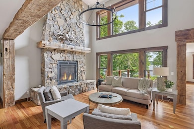 Show-stopping 22' stone fireplace with amazing lake views, are we in Colorado, or where are we?