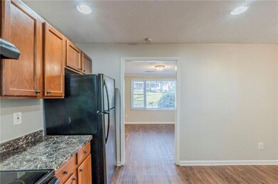 Kitchen with baseboards, dark stone counters, free