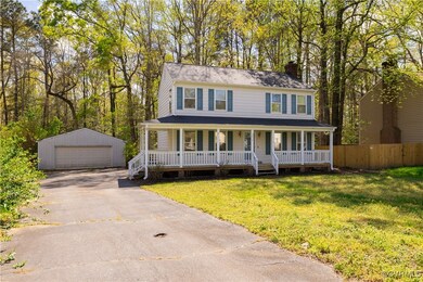 Colonial inspired home featuring a detached garage