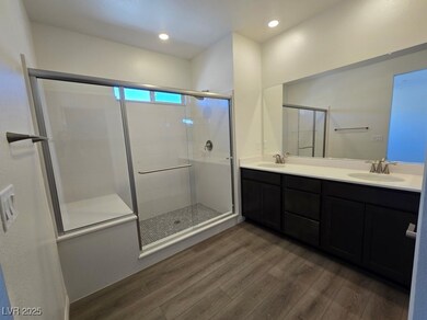 Bathroom with double vanity, a sink, a stall showe