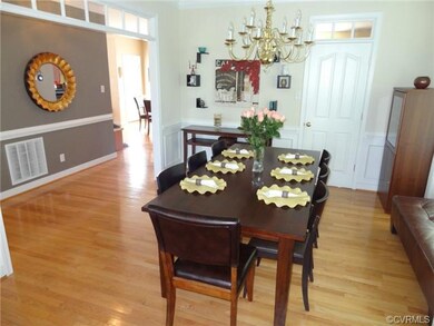 Dining Room with hardwood floors, bay window, crow