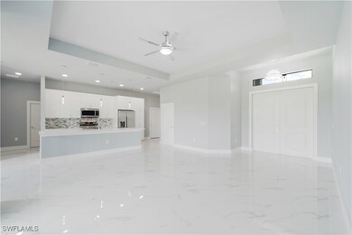 Unfurnished living room with ceiling fan, recessed