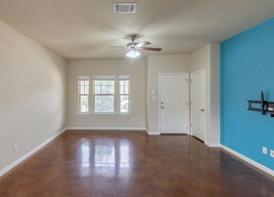 Empty room with a ceiling fan, baseboards, visibl