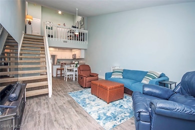 Living room featuring stairs and  tile flooring th
