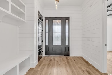 Mudroom featuring light hardwood / wood-style floo