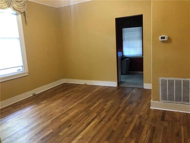 Spare room with dark wood-style flooring and baseb