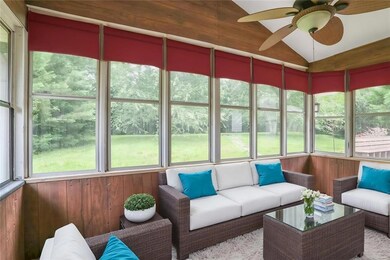 Sunroom featuring a ceiling fan, lofted ceiling, and outdoor lounge area