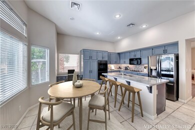 Kitchen featuring black appliances, blue cabinets,