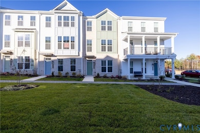 View of front of house with a front yard, brick siding, and a porch